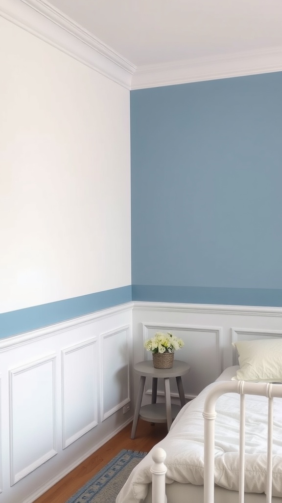 A bedroom with a serene blue and white two-toned wall featuring a chair rail.